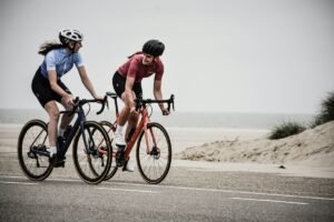 Two road cyclists talking while riding as an example of cycling photography