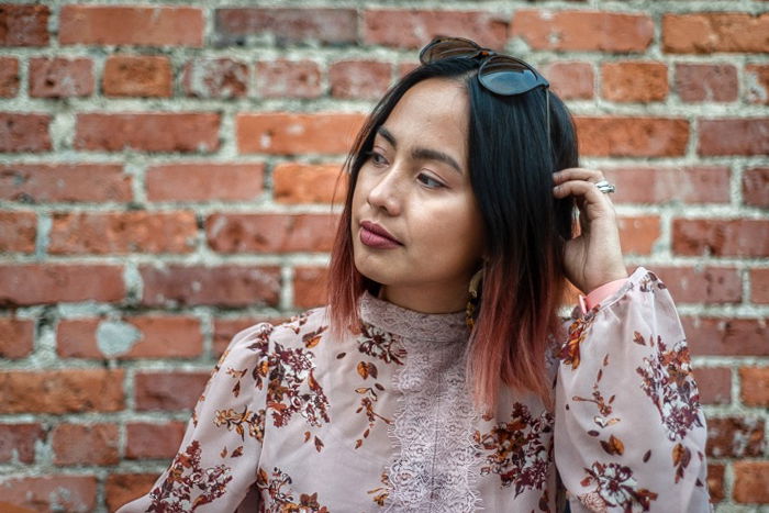 Portrait of a woman in front of a brick wall