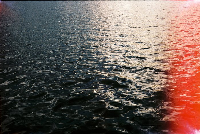 Photo of a waterscape with light leaks
