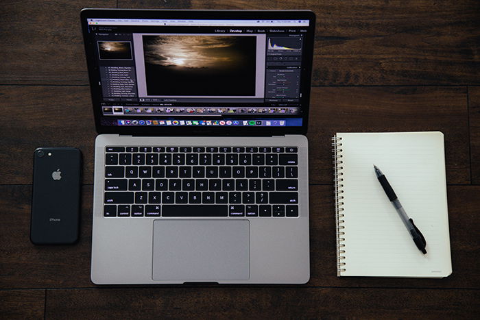 Photo of a laptop and a notepad