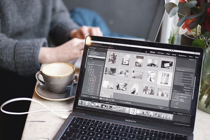 Photo of a laptop with a coffee mug next to it