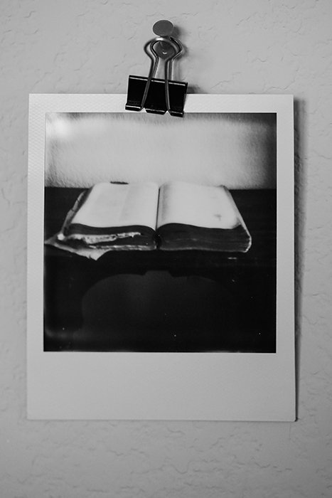 A black and white Polaroid picture of a book
