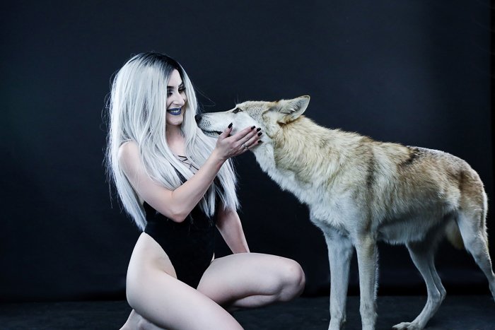 Boudoir photo of a woman with a wolf