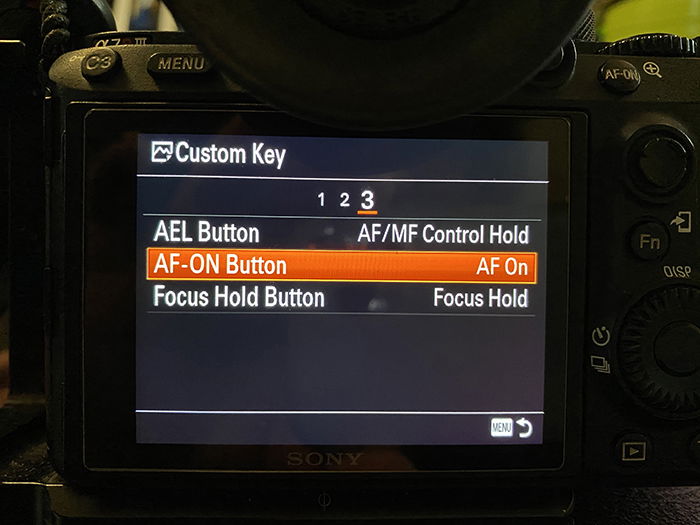 Close-up photo of camera setting menu AF On button