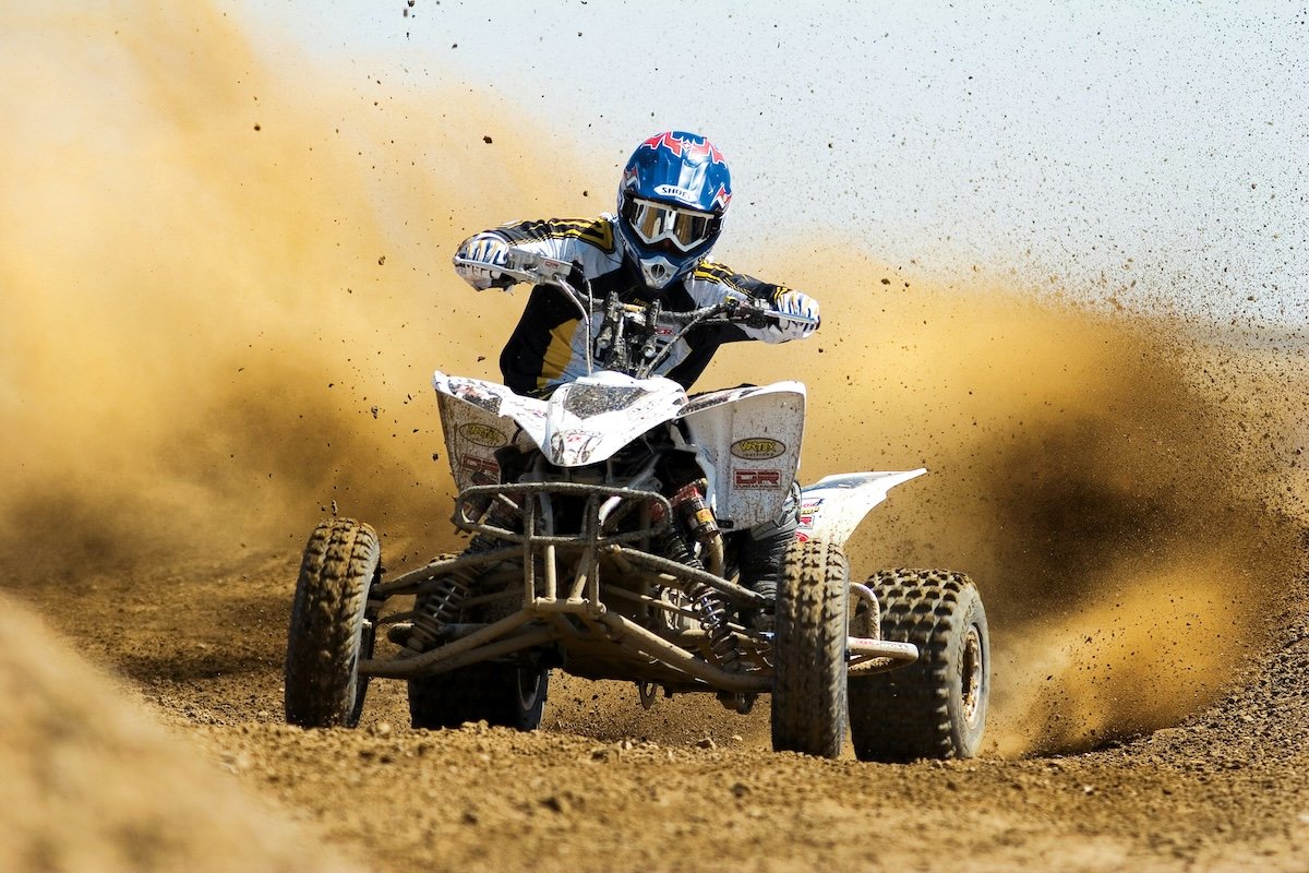 An all-terrain vehicle racer shot from head on as an example of motorsports photography