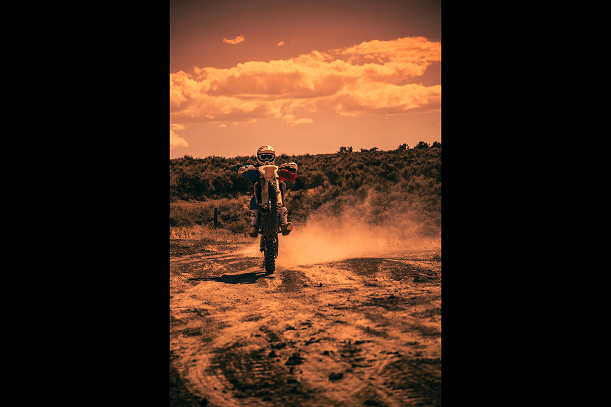 A sepia-colored photo of motocross rider shot from head-on