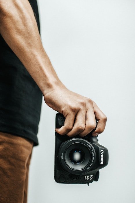Photo of a man holding a camera