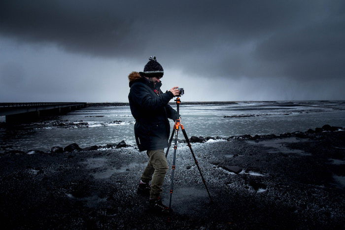 Photo of a photographer with a camera on a tripod