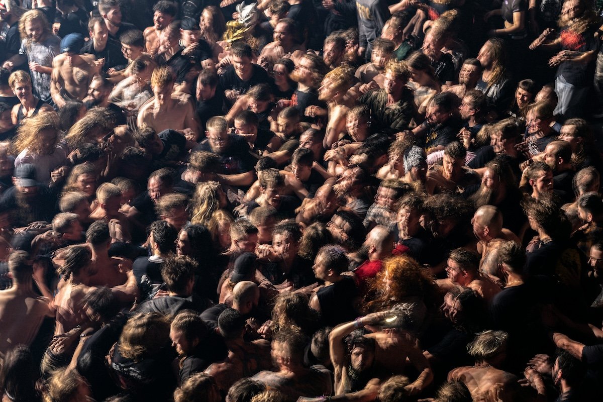 Crowd of people jammed together in a mosh pit at a heavy-metal concert as an example of photography style