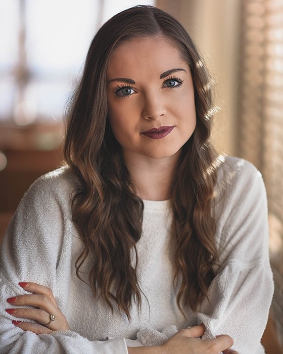 a professional headshot photo of a young woman