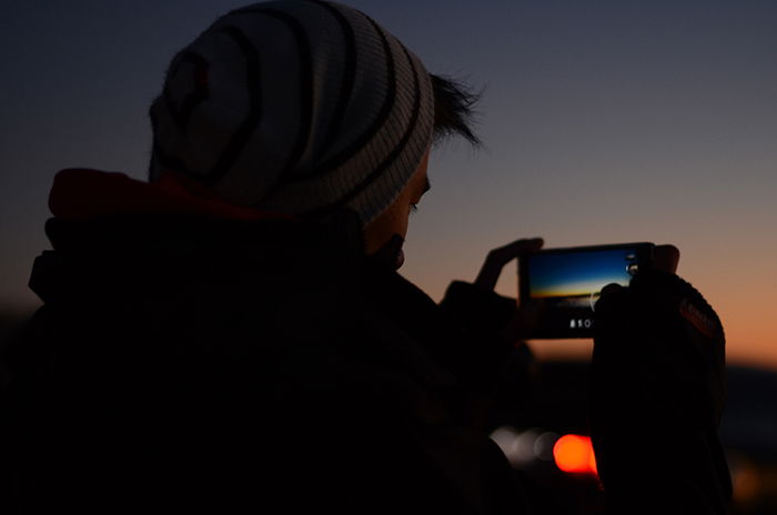 A man taking photos of a sunset 