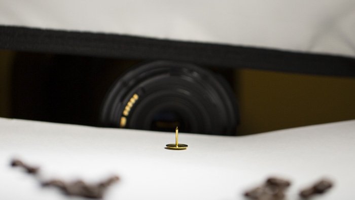 a camera taking a macro photo of a thumb tack