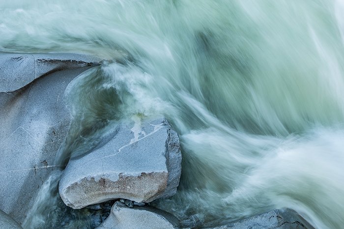 an overhead shot of flowing water beside rocks
