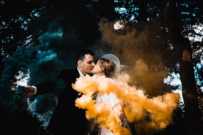 A couple posing with smoke bombs 