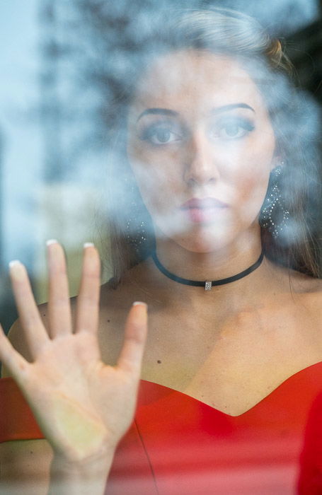 Photo of a woman looking out of a window