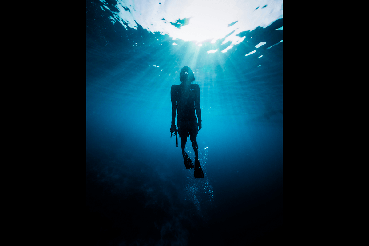 A silhouette of a snorkeler underwater for GoPro photography