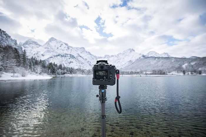 Photo of a camera on a monopod in front of a lake