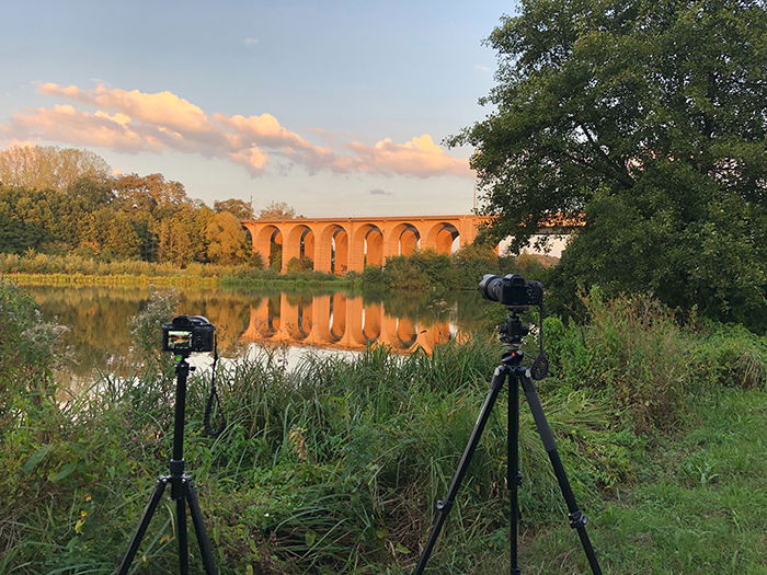 Photo of a camera on a tripod on a field