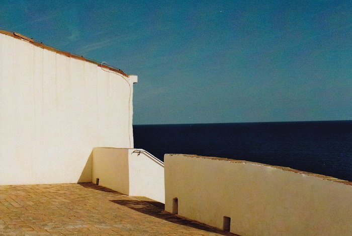 Abstract landscape of white walls and the sea in the background