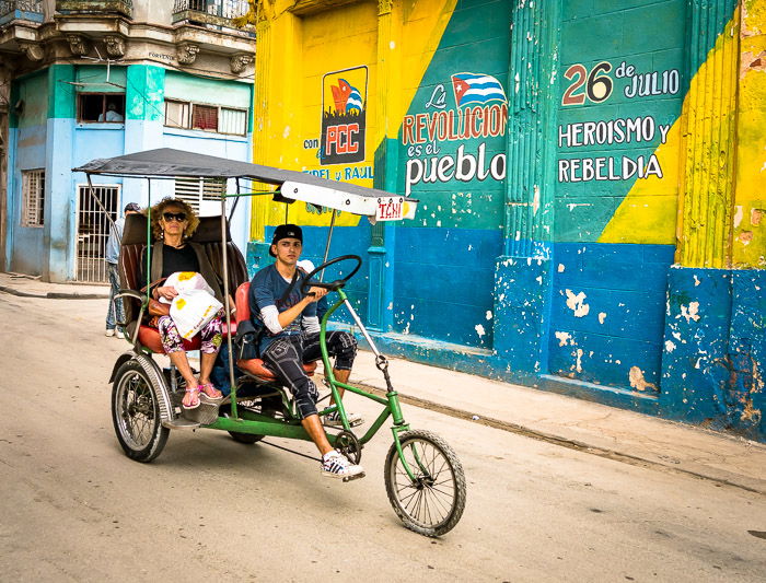 A tuktuk bike on a dusty street