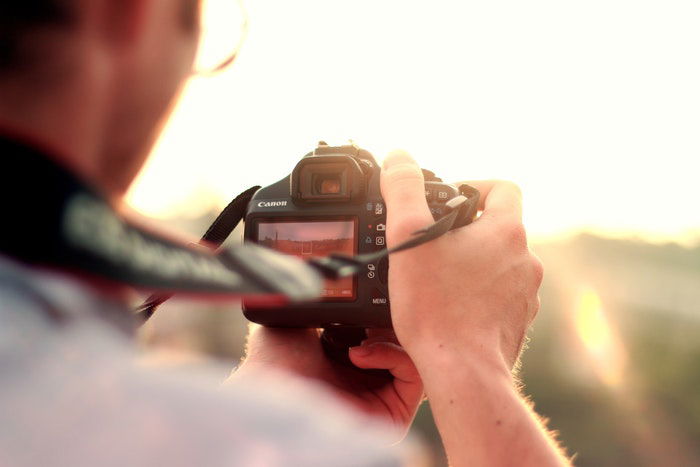 photo of a guy holding a camera - sharp photos