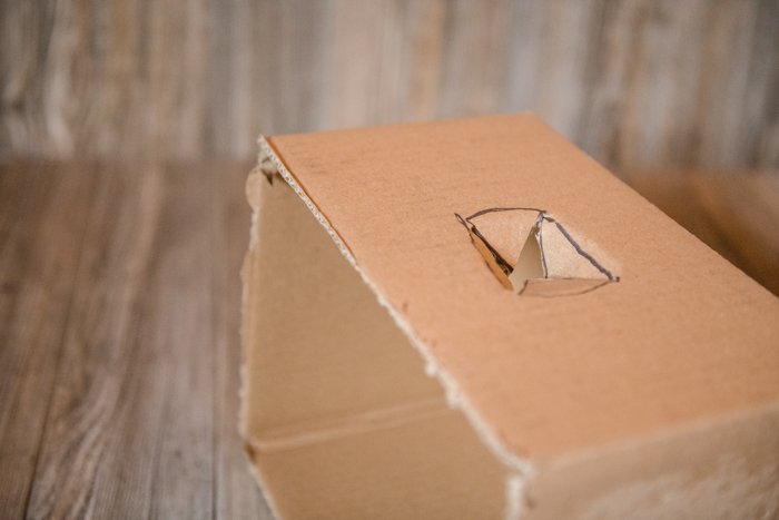 Cutting a cardboard box to make a softbox