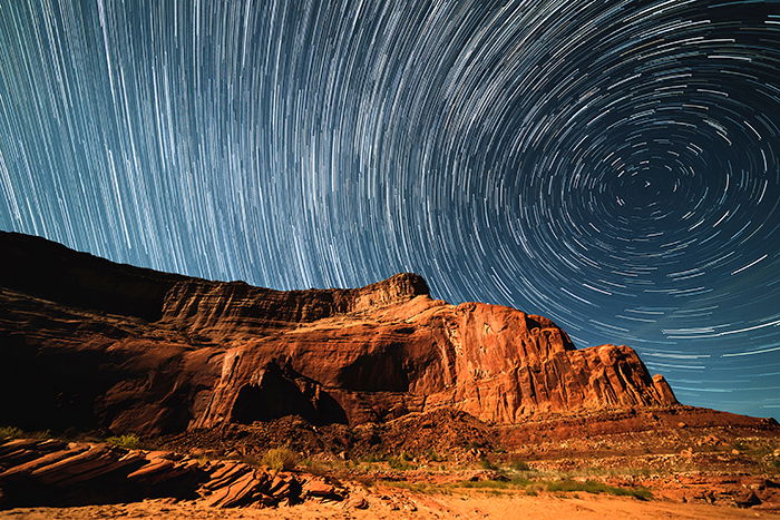 Mountainous landscape with impressive star trails in the sky