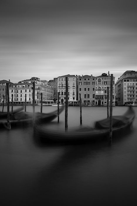 black and white photo of boats in a harbour 