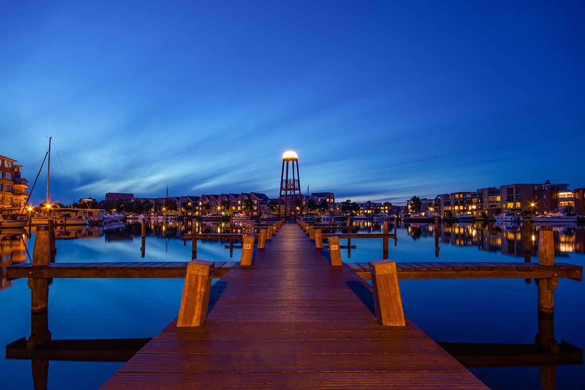 A long-exposure of a pier with a smooth sky and water for time-lapse photography