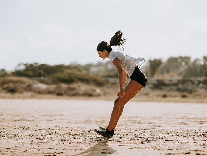A woman working out on the beach