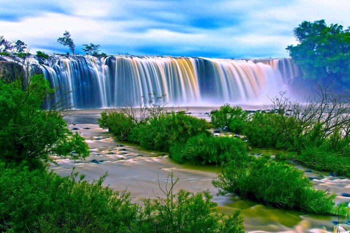 long-exposure image of flowing waterfalls in a lake