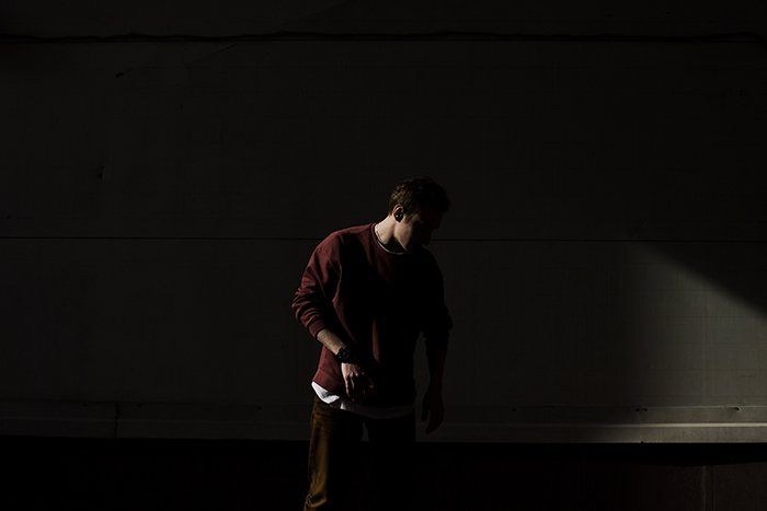 Shadowy portrait of a man in a dark room