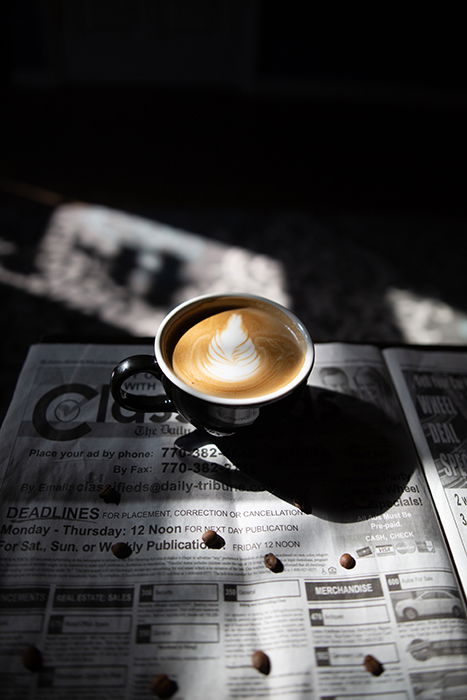 A cup of coffee on a newspaper