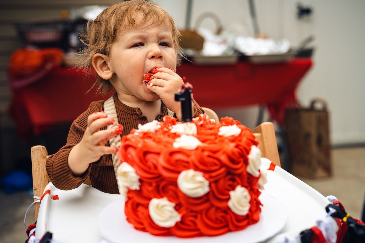 Toddler eating birthday cake