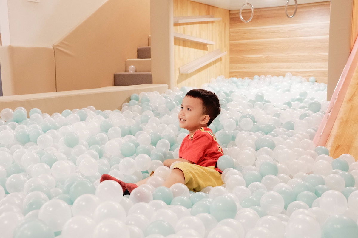 Toddler playing in an indoor play setting