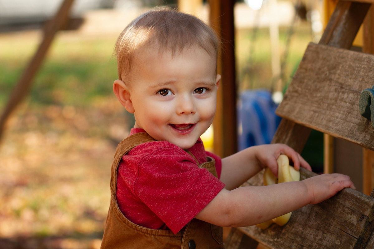 Toddler posing in a playground