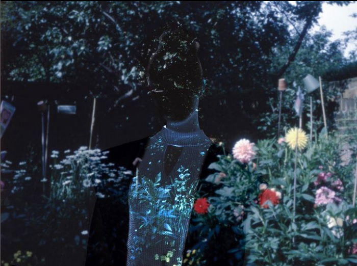 A double-exposure photo of a ghostly figure in a garden for creative editing ideas