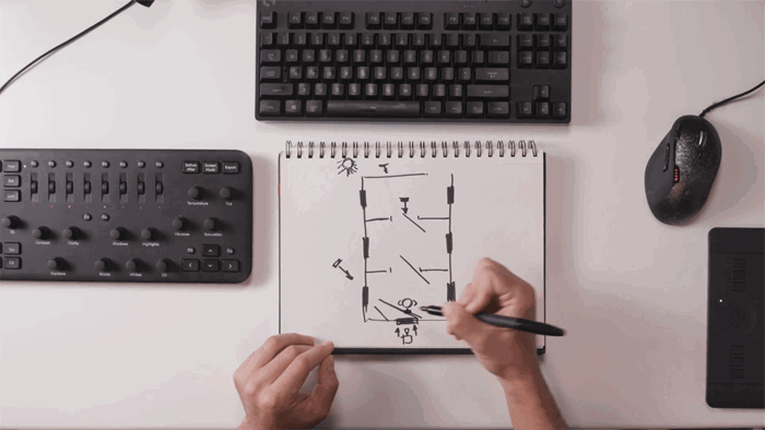 Overhead shot of a person drawing a photography lighting setup diagram 