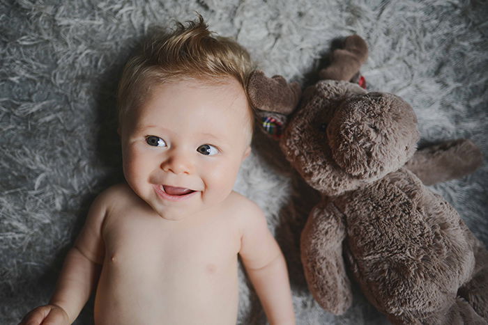 Baby with a stuffed animal.