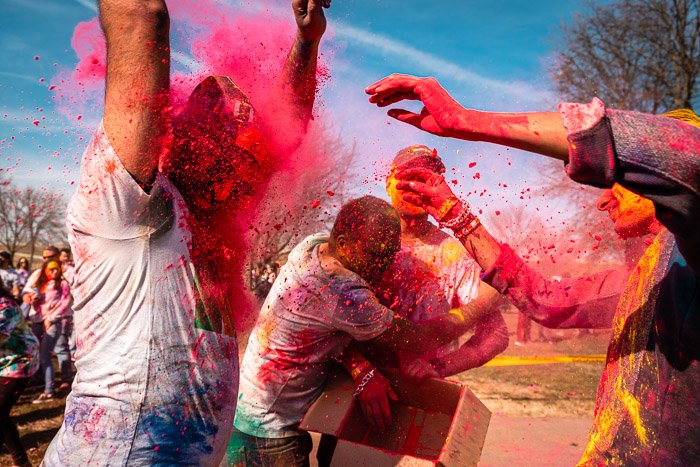 Bright paint thrown in the face of a dancer at a local Holi festival.