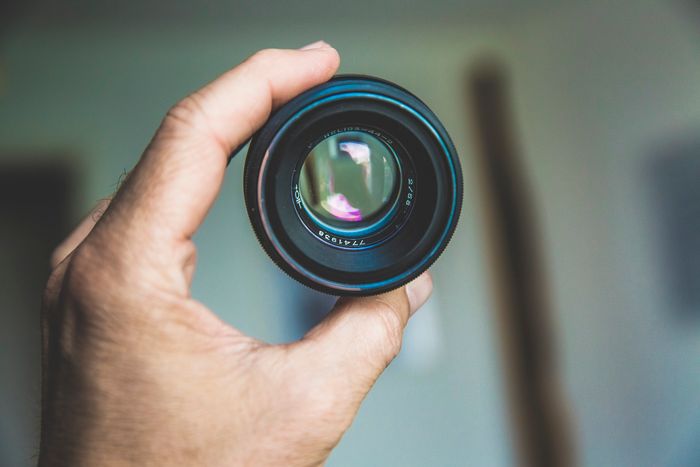 Close-up photo of a hand holding a lens