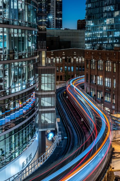 A busy night cityscape with streaming light trails