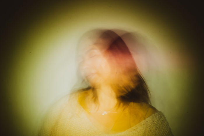 Creative long exposure portrait of a female model in low light