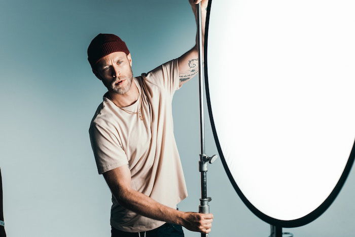 A photography assistant adjusting light