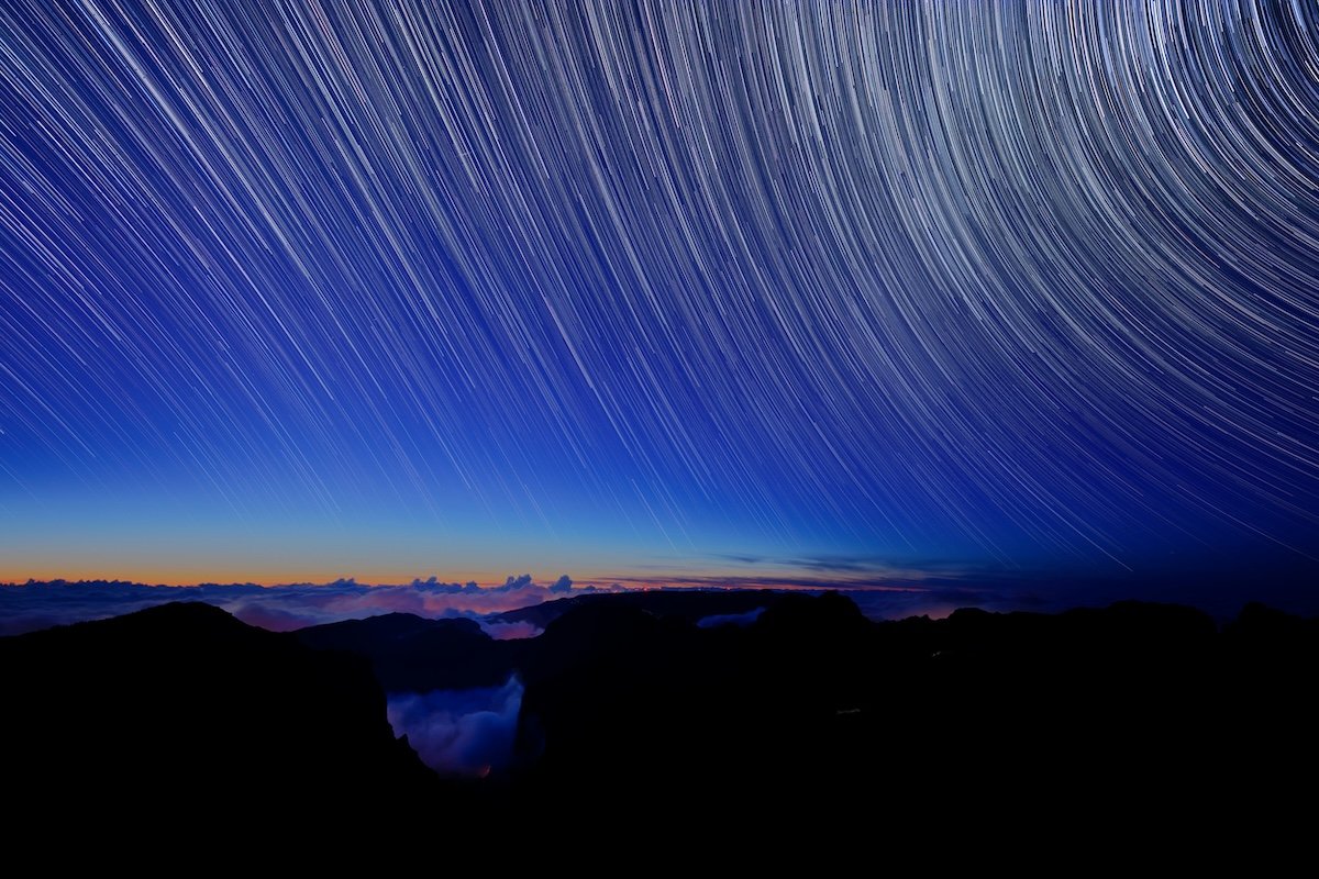Star trails moving in circular patterns in the night sky time-lapse