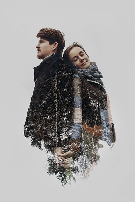 Stylish romantic couple in double exposure with tree branches