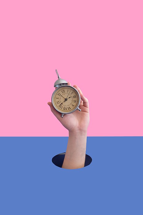 A conceptual still life of a hand holding a clock 