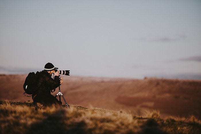A photographer taking a landscape shot