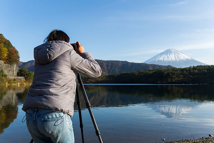 Woman takes a photo with her camera.