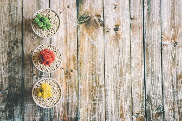 overhead shot of three blows of food on a wooden table